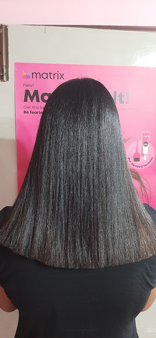 Shoulder-length black hair against a pink poster