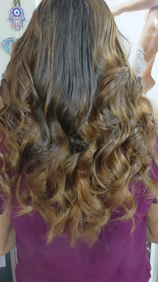 Long honey-brown curls seen from behind